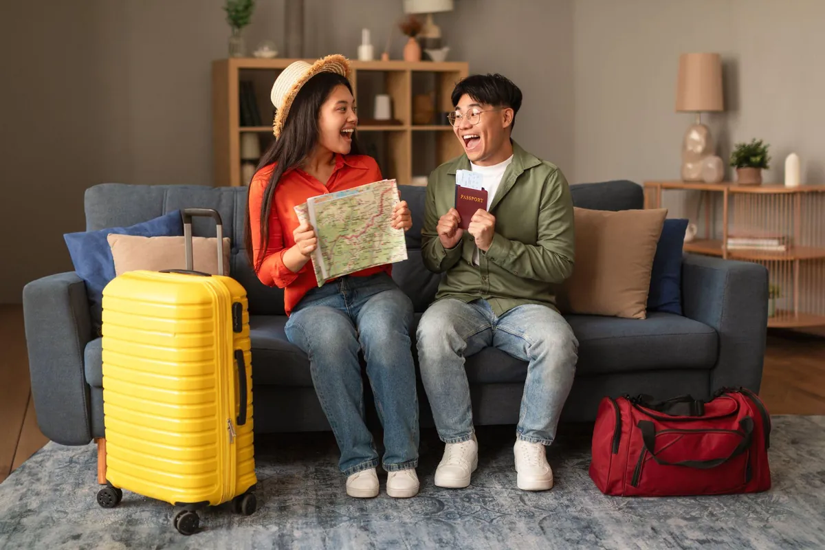 Couple with passports and a map planning their move from Malaysia to Australia
